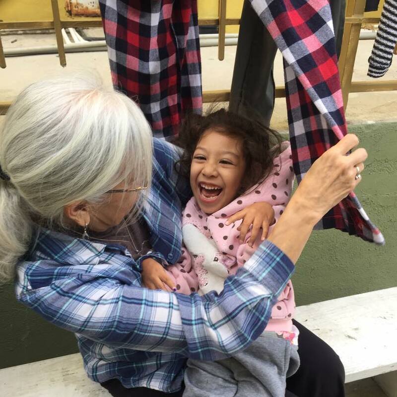 Short Term Mission Trip to Kenya - Mama Mona holding a lovely baby
